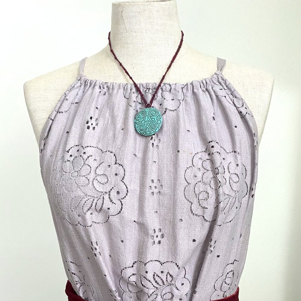 Monet Engraved Turquoise Pendant on a Knotted Band Necklace